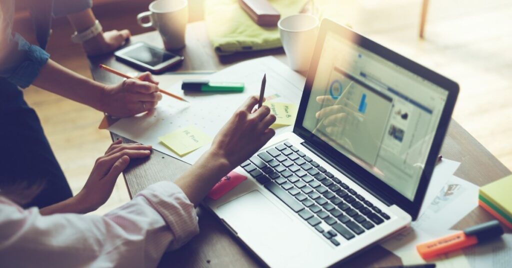 hands on desk with laptop