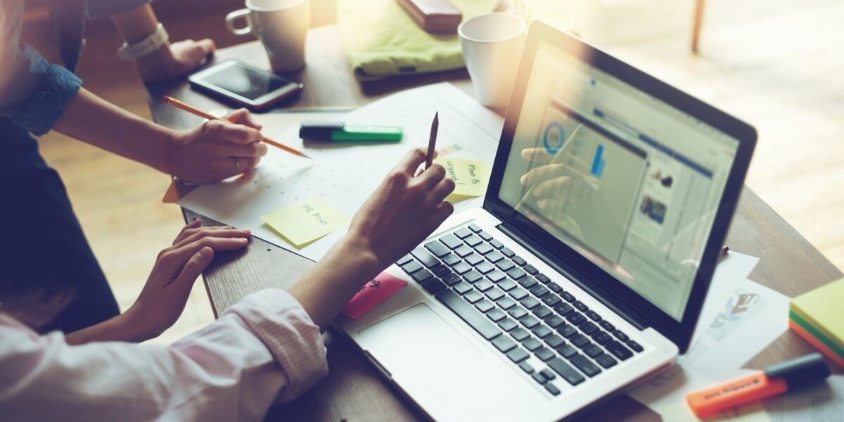 hands on desk with laptop